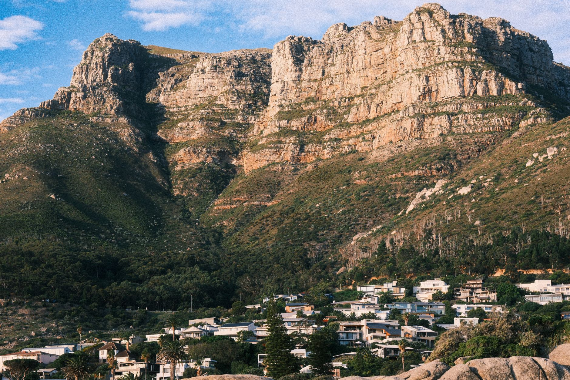 Rocky mountain cliffs rising above hillside homes in Cape Town