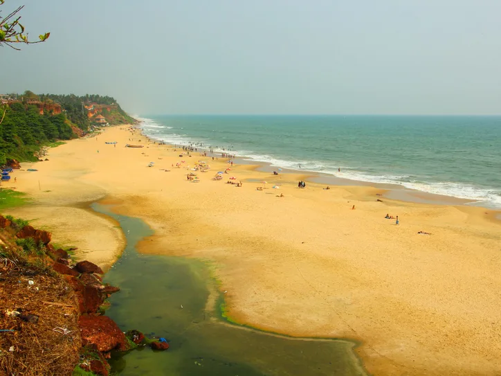 A breathtaking aerial view of Varkala Beach in Kerala, India with golden sands and tranquil waves.