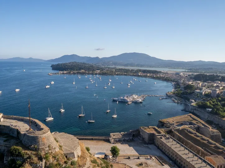 Scenic aerial view of the Old Fortress overlooking the bay with sailboats in Corfu, Greece.