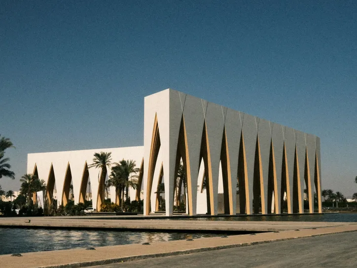 Captivating view of a modern architectural landmark at El Gouna Festival Plaza, surrounded by palm trees.