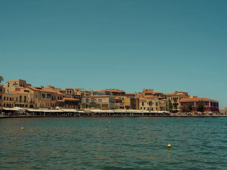 Scenic view of Chania Old Town and harbor, Crete, Greece, under clear blue sky.