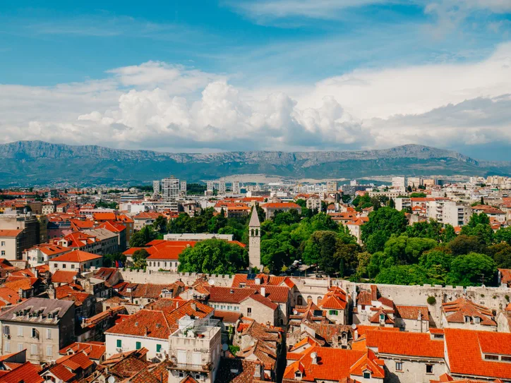 Aerial view of Split, Croatia, featuring red rooftops and the Cathedral of Saint Domnius.