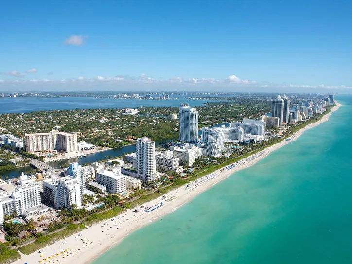 Stunning aerial view of Miami Beach's skyline along the Atlantic Ocean, ideal for travel and adventure imagery.