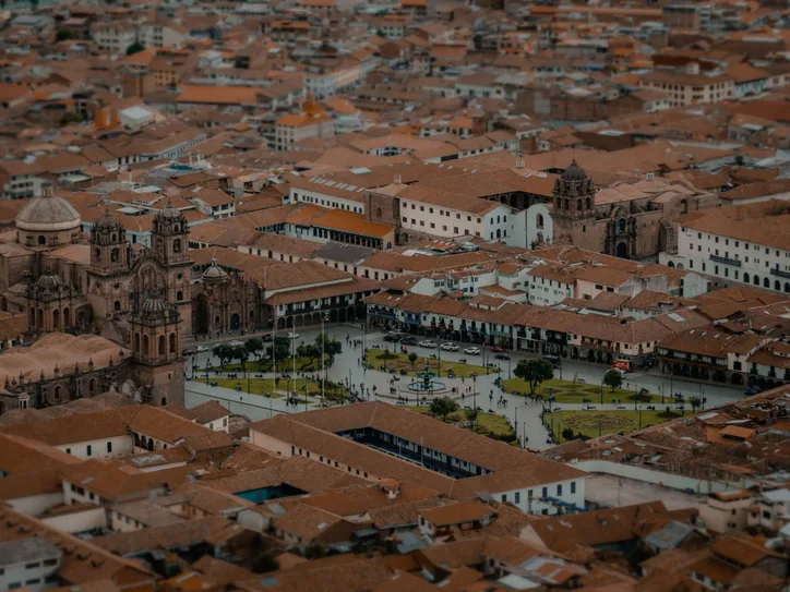 Drone view capturing the Plaza de Armas, Cusco, with its historic architecture and vibrant cityscape.