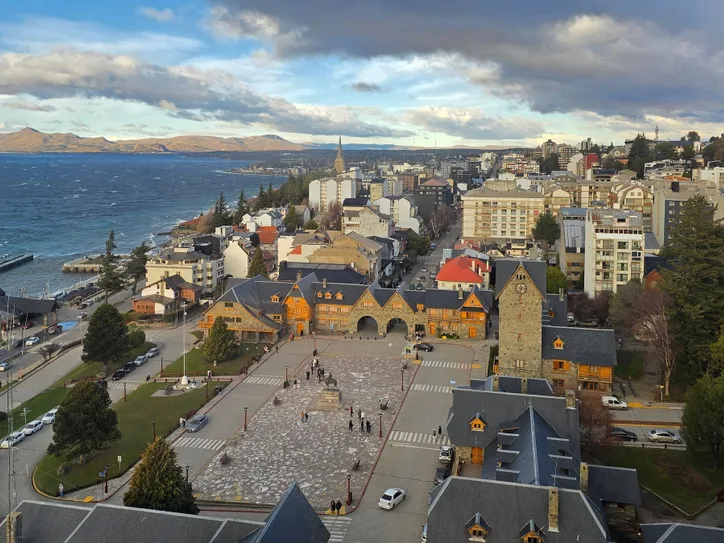 A picturesque aerial view of San Carlos de Bariloche, Argentina showcasing the town and Nahuel Huapi Lake.