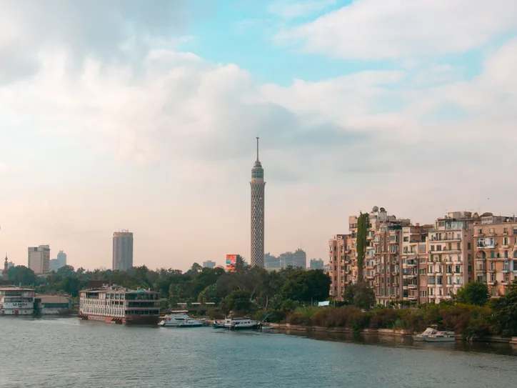 Beautiful view of Cairo skyline featuring the iconic Cairo Tower and downtown architecture along the Nile River.