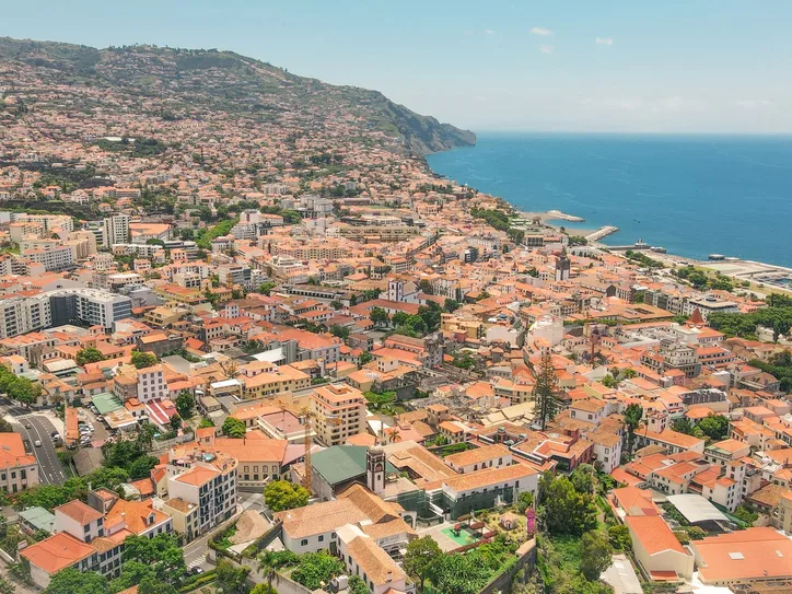 Explore the vibrant aerial view of Funchal, Madeira, showcasing its coastal urban landscape and scenic beauty.