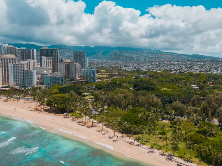 Stunning aerial view of Waikiki Beach with the skyscrapers of Honolulu in the backdrop.