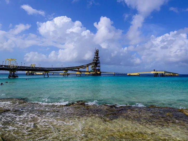 Beautiful coastal view with a pier extending into the turquoise Caribbean Sea in Bonaire.