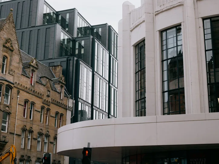 A blend of modern and Victorian architecture in Glasgow, Scotland, showcasing urban contrast.