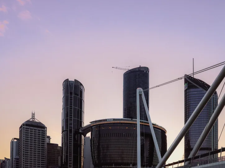 Captivating view of Brisbane's skyline at sunset, showcasing modern skyscrapers and urban architecture.