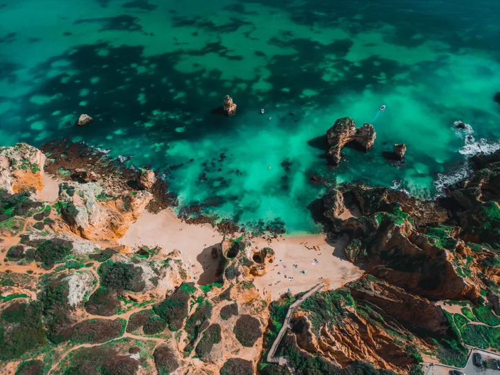 Explore the breathtaking Algarve coastline with its turquoise waters and stunning rock formations in Lagos, Portugal.