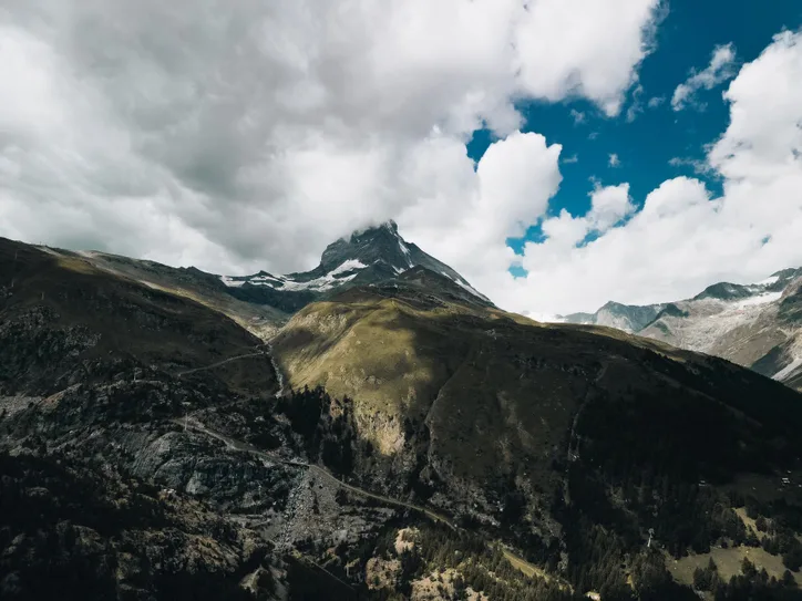 Discover the majestic Matterhorn mountain in Zermatt, Switzerland under dramatic clouds and blue skies.