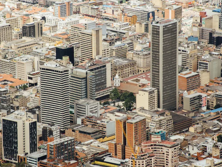 Aerial cityscape of downtown Bogotá featuring modern skyscrapers and urban architecture.