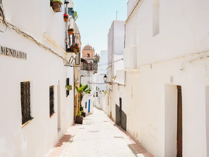 A sunlit view of the iconic white streets in Tarifa, Andalusia, Spain, embodying Mediterranean charm.