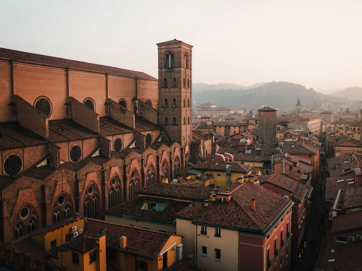 A breathtaking aerial view of Bologna's historic architecture at dusk, highlighting its rustic charm.