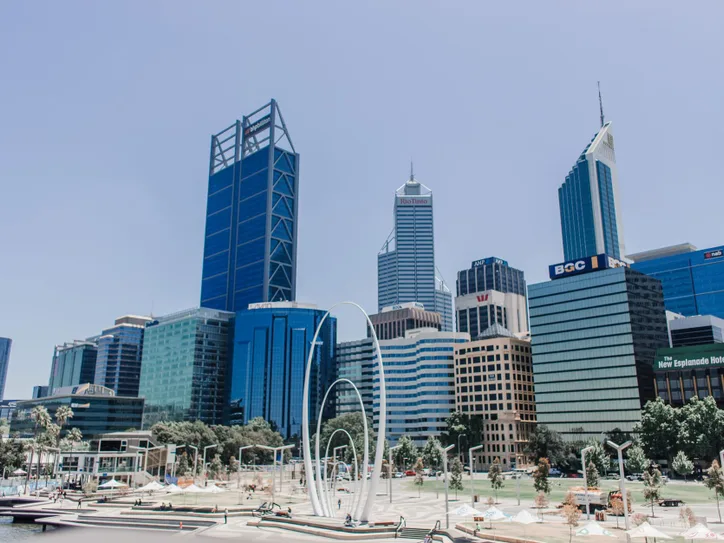 Vibrant skyline of Perth featuring iconic skyscrapers under a clear blue sky.