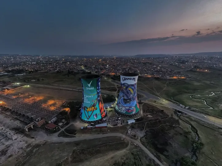 A stunning aerial view of the iconic Orlando Towers in Johannesburg at twilight, showcasing the vibrant cityscape.
