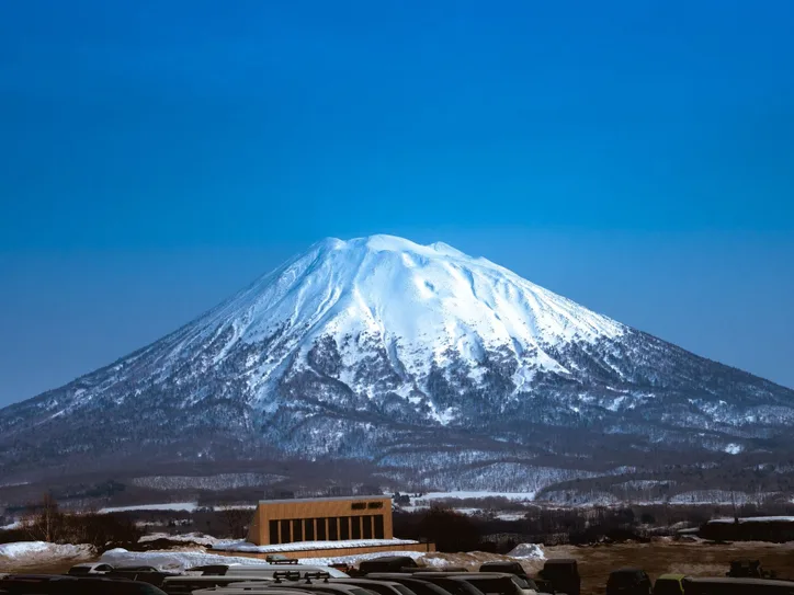Stunning view of snowcapped Mount Yotei in Niseko, Hokkaido with a clear blue sky.