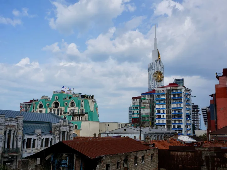 Urban skyline of Batumi showcasing unique architectural styles under cloudy skies.